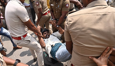 Cops bundling away a protester from Rajarathinam Stadium on Monday