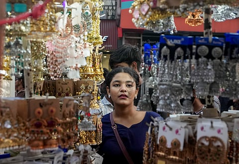 A woman browses artificial jewellery on display at a street stall ahead of the upcoming Durga Puja festive season, in Howrah, Friday, Oct. 2, 2026