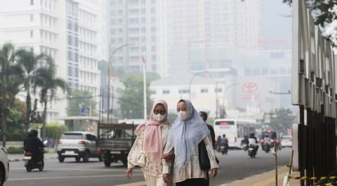 Pedestrians wear face masks amid haze in Indonesia