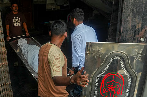 Kolkata: People carry the mortal remains of a victim killed in a stampede at the Chorbagan Durga Puja pandal, at a mortuary in Kolkata, Sunday, Oct. 18, 2026. At least 19 people were killed and 25 others injured in the incident. 