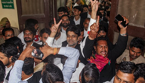 Lawyers and onlookers gesture victory signs inside the court premises after a Meerut court sentenced Muskan Rastogi and her partner Sahil Shukla to death in the Saurabh Rajput murder case