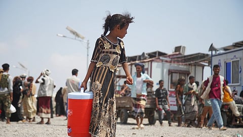 A displaced Yemeni girl walks at Al-Firdaws 2 camp in Ras Imran, on the western outskirts of Aden,