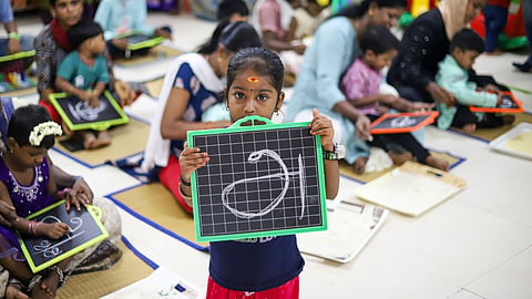 Children writing Tamil letters on slate boards with their mothers’ help at Presidency Girls Higher Secondary School in Egmore