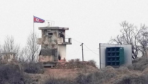 A soldier stands at a North Korean military guard post next to loudspeakers, seen from Paju, South Korea, near the border with North Korea