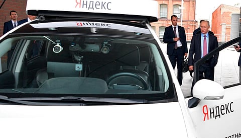 Russian President Vladimir Putin, right, examines a prototype of a driverless vehicle during a visit to the headquarters of tech giant Yandex in Moscow, Russia