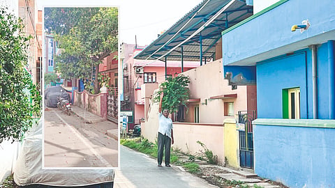 A broken power line hangs from the main line, and an overhead cable sags in front in Girija Nagar, Ernavoor
