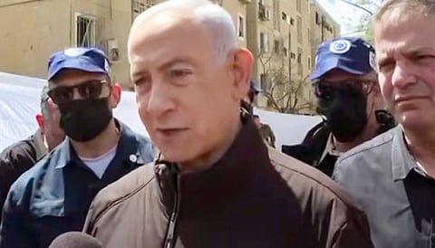 Israel Prime Minister Benjamin Netanyahu speaks to media during a visit to the southern Israeli city of Arad, which faced Iranian missile strikes on Saturday