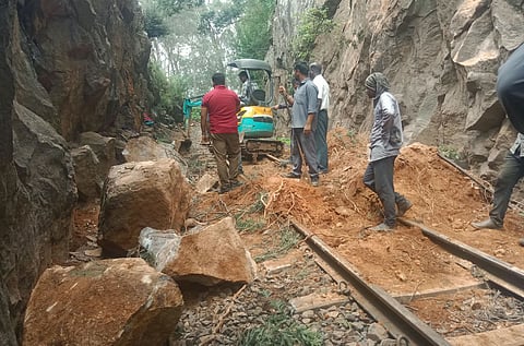 Workers clear mud from tracks on Tuesday following a landslip on the Nilgiri Mountain Railway route