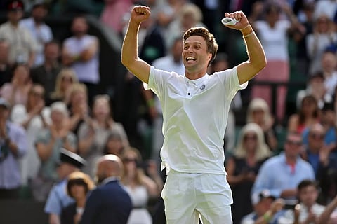 Liam Broady celebrates a memorable victory