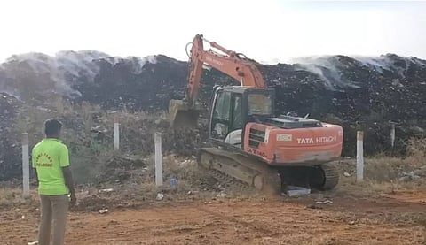 Smoke emanating from the garbage mound in Karur on Tuesday
