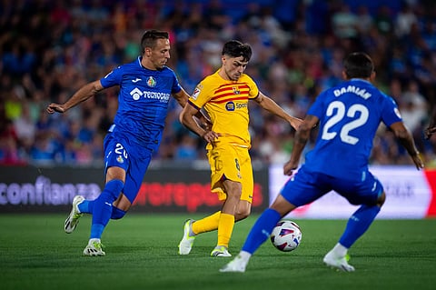 Barcelona’s Pedri contesting for the ball with Getafe players
