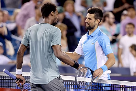 Gael Monfils and Novak Djokovic meet at the net after their match