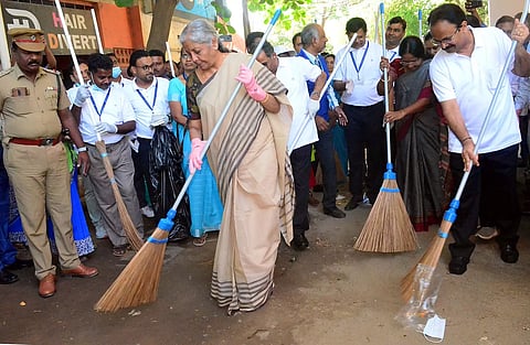 Union Minister Nirmala Sitharman cleans the street as part of cleanliness drive in Coimbatore, on Tuesday