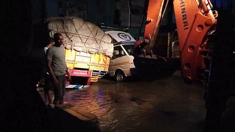 Excavator deployed to pull out a lorry stuck in Pallipalayam, Namakkal