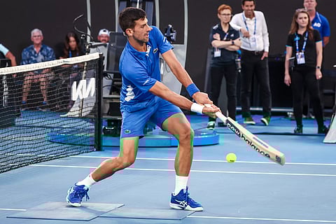 Novak Djokovic plays cricket during a charity event in Melbourne