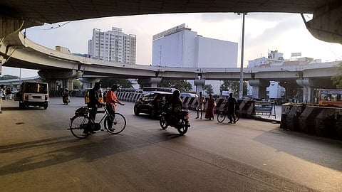 Pedestrians cross busy Jawaharlal Nehru Salai below the flyover in Padi
