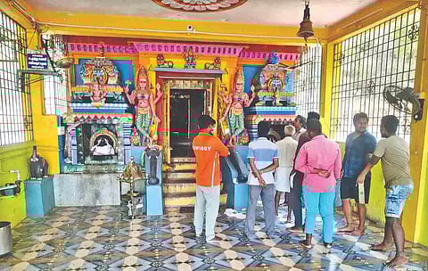 People check on the temple which was burgled.