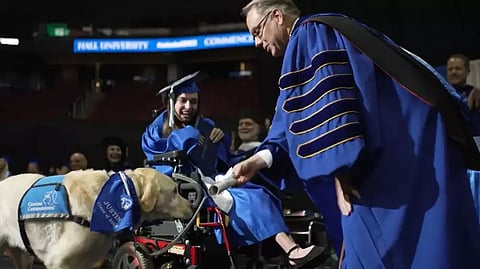 Devoted dog receives diploma alongside his human