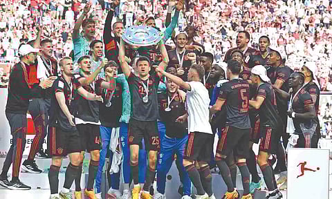 Bayern Munich’s players celebrate with the trophy