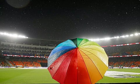 A person holding umbrella in the stadium. Credit: Twitter - @ChennaiIPL
