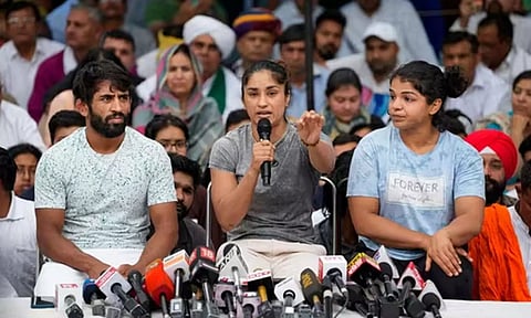 Wrestlers Bajrang Punia, Vinesh Phogat and Sakshi Malik speak with the media during their protest at Jantar Mantar, in New Delhi, Saturday, April 29, 2023 (PTI)