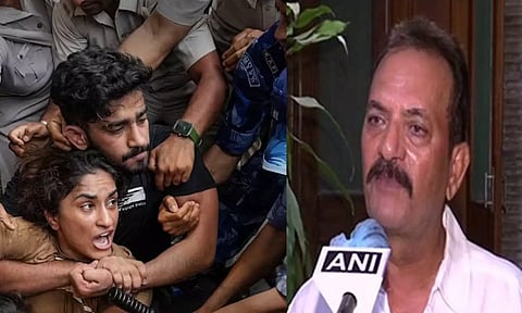 Security personnel detain wrestler Vinesh Phogat during wrestlers' protest march towards new Parl building; Madan Lal (ANI &amp; PTI)