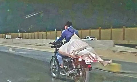 Image of mannequin carried on bike shared falsely