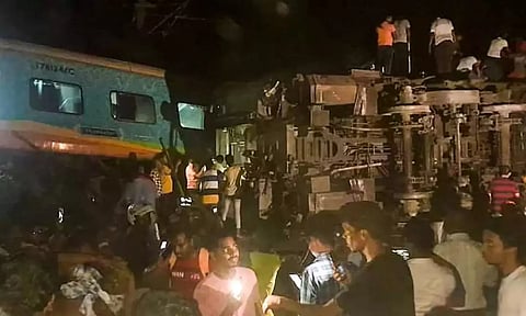 People at the accident spot. PTI