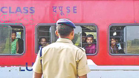 A police official stands guard as train services resume on the ill-fated tracks of Balasore
