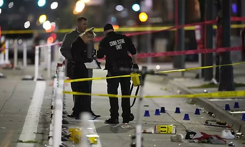 Denver Police Department investigators work on the scene of a mass shooting along Market Street between 20th and 21st avenues during a celebration after the Denver Nuggets won the team's first NBA Championship. (AP)