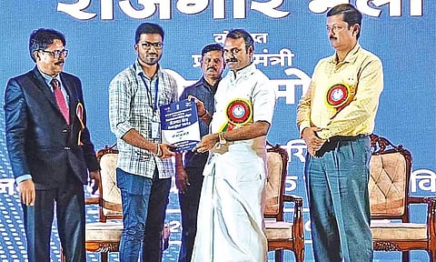 Union Minister L Murugan distributing job orders in Tiruchy on Tuesday