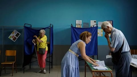 People cast their votes at a polling station, during the general election, in Athens, Greece
