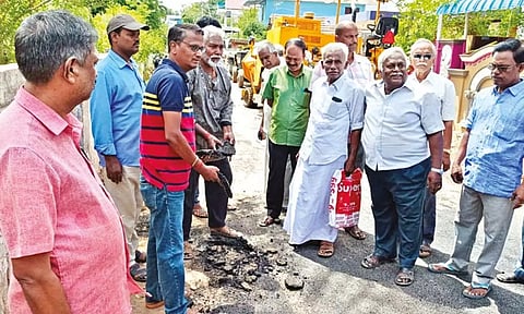 Residents peeling off the tar from the newly-laid road in Thanjavur on Monday