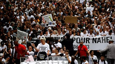 Mounia, the mother of Nahel, a 17-year-old teenager killed by a French police officer in Nanterre during a traffic stop, and relatives stand on a van as they attend a march in tribute to Nahel in Nanterre