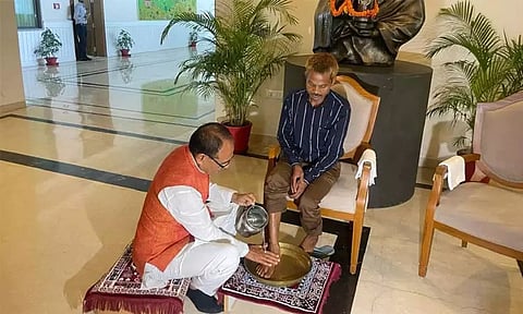 CM Shivraj Singh Chouhan washes feet of urination case victim in Bhopal. (ANI)