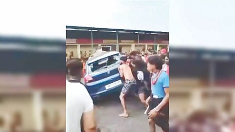 Group of Kanwariyas roughing up a man sitting in a car
