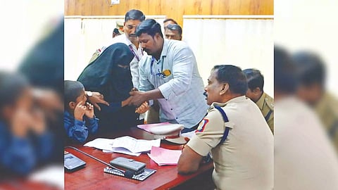 Cops prevent a woman from cutting her wrist during weekly grievances day meet in Vellore on Wednesday