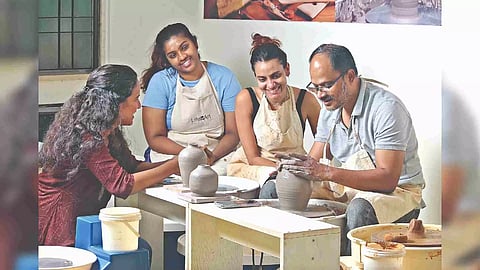 Youngsters learning pottery from Dewakar Chandran