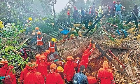 Rescuers work at the landslide site in Raigad district, Maharashtra on Thursday (AP)