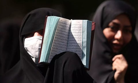 A Muslim showing Koran. Reuters