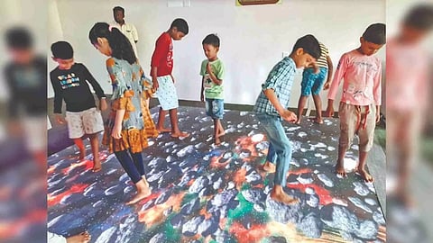 Children revel at the interactive LED floor on Saturday