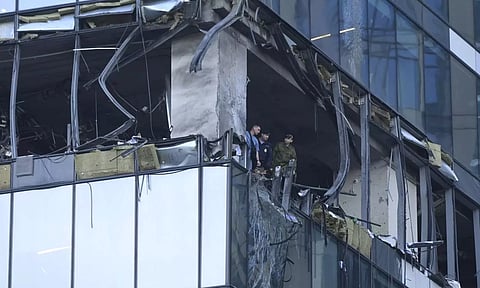 Investigators examine a damaged skyscraper in the "Moscow City" business district after a reported drone attack in Moscow, Russia, early Sunday. (AP)