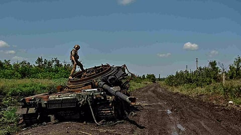 A Ukrainian serviceman inspects a destroyed Russian tank in the recently liberated village of Novodarivka, amid Russia's attack on Ukraine, in Zaporizhzhia region, Ukraine (Photo: Reuters)

