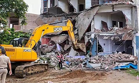 Bulldozer being used to demolish Sahara Hotel in Nuh district on August 6. (PTI)&nbsp;
