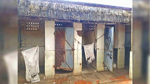 Pieces of cloth guard privacy of women cleanliness workers at the damaged toilets in Municipal Colony
