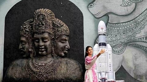 A young woman takes a selfie along with a cutout of the Chandrayaan 3 Launch Vehicle Mark-III outside a temple in Mumbai, India, July 14, 2023 (Photo/Reuters)