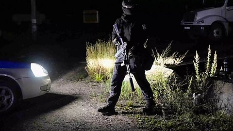 Lamps Illuminate parts of a private jet after a crash near the village of Kuzhenkino, Tver region, Russia, Thursday, Aug. 24, 2023