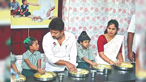 Minister Udhayanidhi Stalin and Chennai Mayor R Priya having breakfast with students at a school in Triplicane on Friday