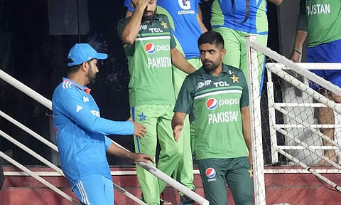 Babar Azam shakes hands with Rohit Sharma after the match was called-off