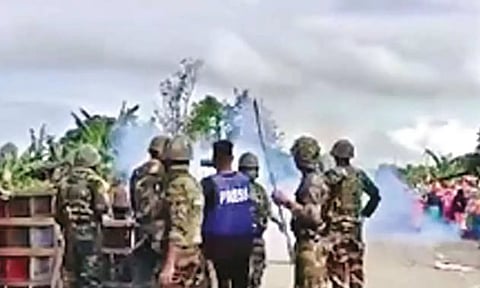 Security personnel facing the mob